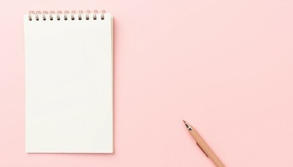 Blank notepad and pen on pink