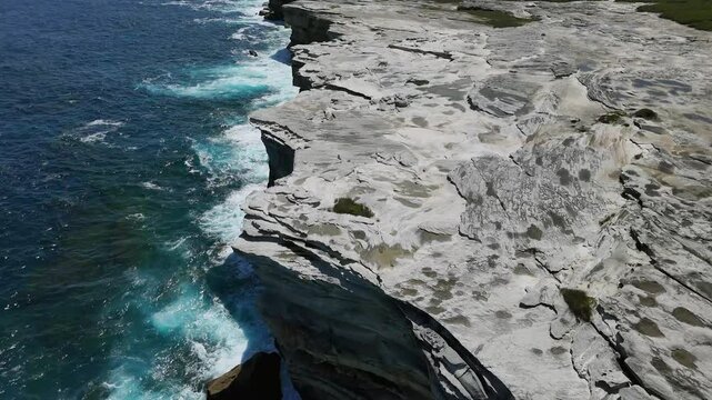 Kurnell, Sydney, Australia -UHD Drone Video: Flying over the Cape Baily coastline in Kamay National Park, South Sydney with rugged sandstone cliffs.