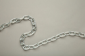 Iron chain of light metal on grey background.
