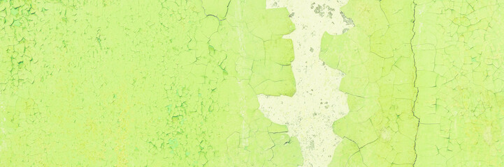 Peeling paint on the wall. Panorama of a concrete wall with old cracked flaking paint. Weathered...