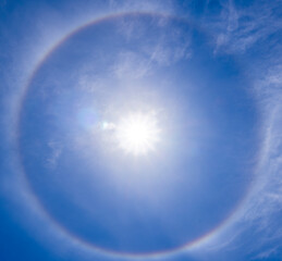 A beautiful rare atmospheric phenomenon of halo in the blue day sky.A halo is an optical...