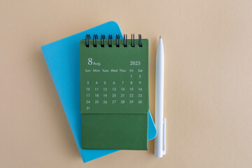 Hello, August 2025. Desktop calendar and notepad for writing on the desktop.