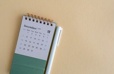 Hello, December 2025. Desktop calendar on beige background.