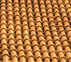 orange and brown old tile roof texture background. Old vintage roof tiles backdrop for concept and...