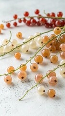 A vibrant assortment of red white and golden currants scattered across a textured surface