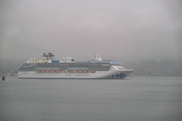 Modern Princess cruiseship cruise ship liner Coral arrival into Vancouver, Canada port on grey...