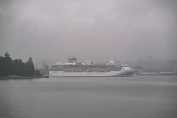 Modern Princess cruiseship cruise ship liner Coral arrival into Vancouver, Canada port on grey...