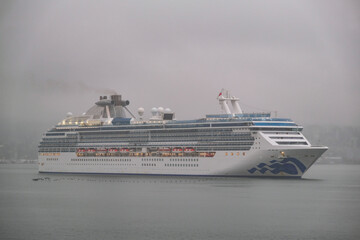 Modern Princess cruiseship cruise ship liner Coral arrival into Vancouver, Canada port on grey...