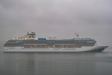 Modern Princess cruiseship cruise ship liner Coral arrival into Vancouver, Canada port on grey...