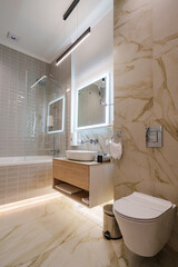 The interior of a modern bathroom is in beige tones.
