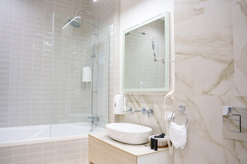 The interior of a modern bathroom is in beige tones.