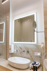 Modern sink washbasin in the bathroom with electronic mirror.