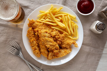 Homemade Chicken Strips with Fries on a Plate, top view.