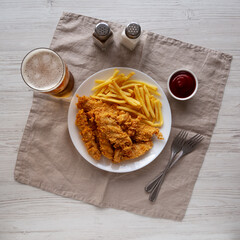 Homemade Chicken Strips with Fries on a Plate, top view. Flat lay.