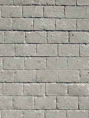 Gray concrete pavement with patterns reminiscent of old stone with brickwork. Covering the pavement...