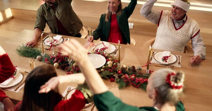 Happy family, Christmas and dining table with hands together above for festive celebration in home. Top view, group or people with pile or stack in solidarity for December holiday or feast in house