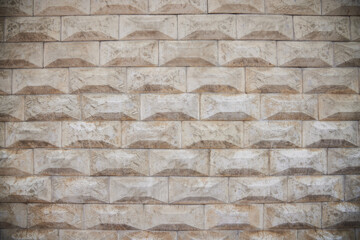 The texture of the wall, lined with curly beige tiles