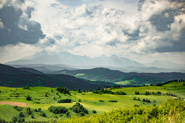 A panorama of Tatry mountain from the Pieniny in a sunny day with a dramatic sky and clouds