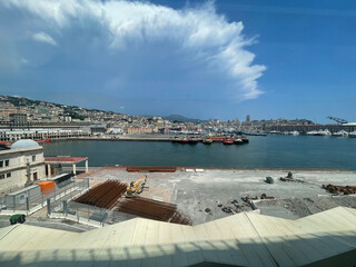 Panoramic view of the harbor of Genoa, Italy, with colorful historic buildings, construction...