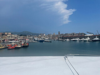 Panoramic view of the harbor of Genoa, Italy, with colorful historic buildings, construction...