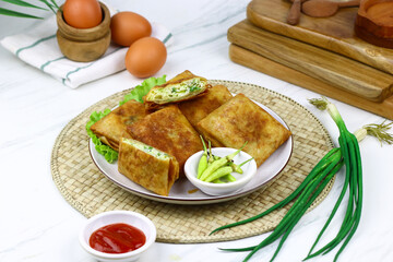 Martabak telur, Indonesian popular folded omelet made from egg, green onion, and wrapped with...