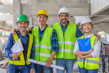 portrait diverse engineering team in safety gears standing and posing to camera while working in a...