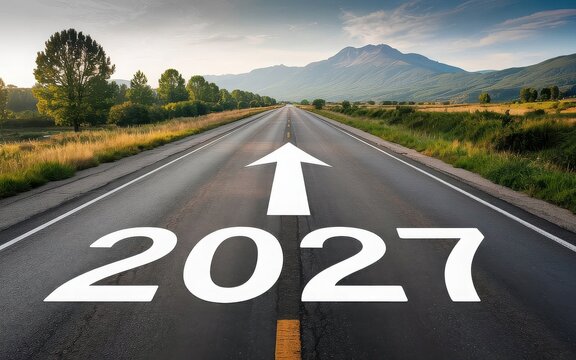 New year 2027 written on the road in the middle of asphalt road at sunset. Concept of planning , challenge,