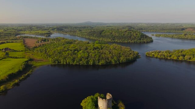 Cloughoughter Castle In Lough Oughter Lake With Green Forest In Killeshandra in County Cavan, Ireland. - aerial pullback shop