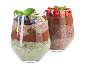 Delicious chocolate puddings with chia seeds, mint and berries in glasses isolated on white