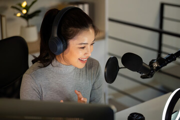Podcasting. Happy woman hosting her podcast session with professional equipment.