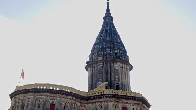 Raj Dwar Mandir spire with Clear Sky Background and orange flag. day time, slowly tilt down, 4k.
