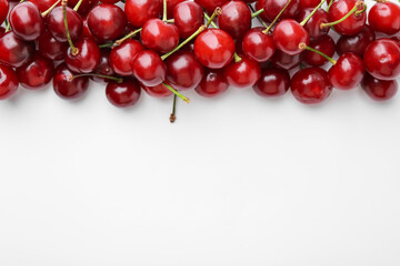 Fresh ripe cherries on white background, flat lay. Space for text