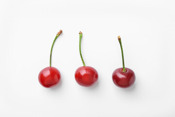 Fresh ripe cherries on white background, flat lay