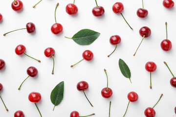 Fresh ripe cherries on white background, flat lay