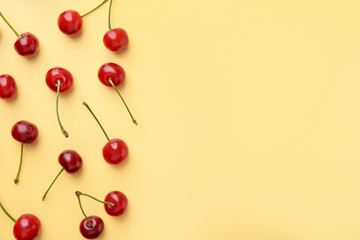 Fresh ripe cherries on beige background, flat lay. Space for text