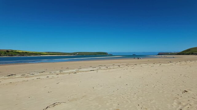 Pan from right to left of Daymer Bay beach and Padstow, Cornwall, UK