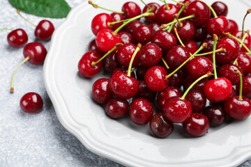 Wet ripe cherries on light table, closeup