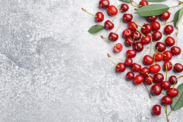 Fresh ripe cherries on light table, flat lay. Space for text