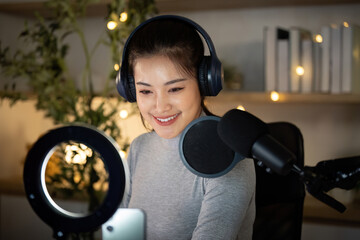 Podcasting. Engaging woman recording her podcast with microphone and headphones.