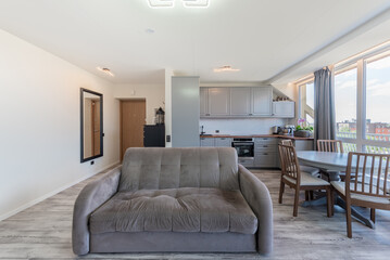 Modern Home Open Living Room With Sofas and Large Windows Overlooking City Scene