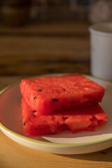 Even slices of sliced watermelon on a plate on a table