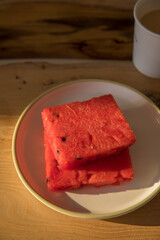 Even slices of sliced watermelon on a plate on a table