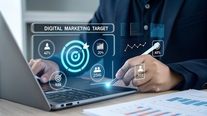 A person is focusing on digital marketing goals and data analytics on a laptop, using a stylus to interact with the interactive screen.