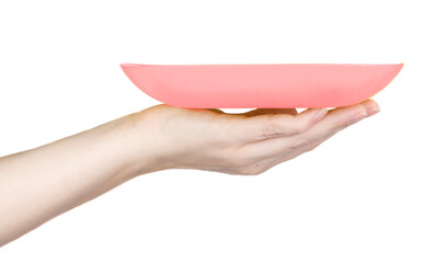 pink plate on a female hand on a white background
