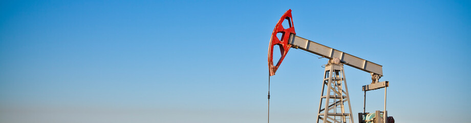 oil pump against sky background banner