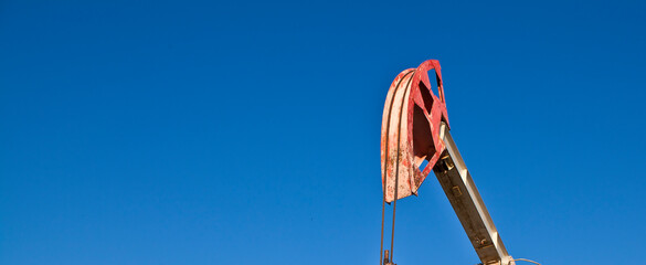 oil pump against sky background banner