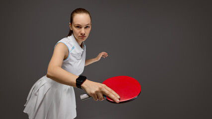 A dedicated table tennis player prepares to strike the ball, demonstrating intense focus. Idea of...