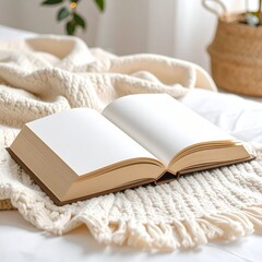 Open blank book on a soft blanket, soft angle view, neutral tones 