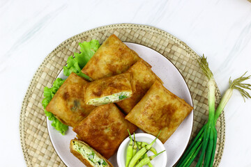 Martabak telur, Indonesian popular folded omelet made from egg, green onion, and wrapped with...