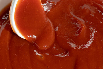 Macro of Ketchup in Spoon. Natural Red Sauce Close-Up